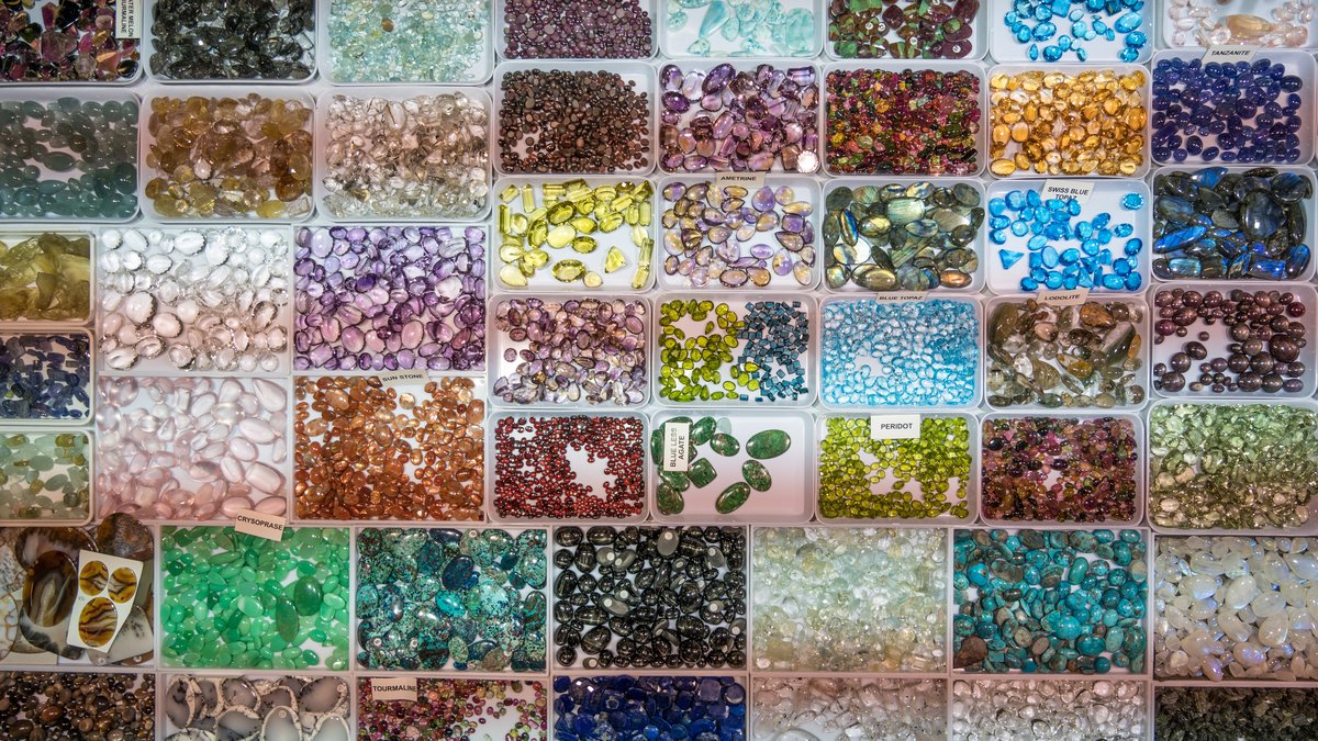 Array of polished healing crystals on a white surface