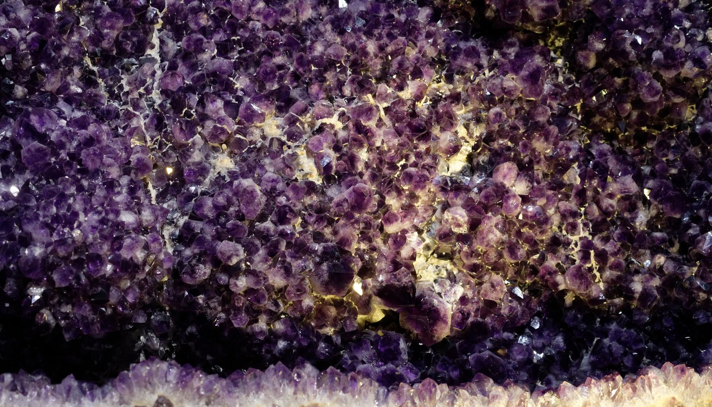 Certified gemstones and healing crystals arranged on a white surface